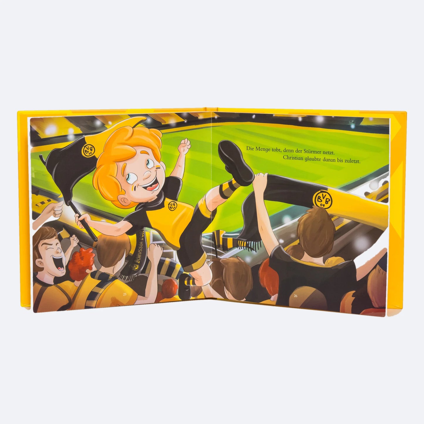 Das Buch aufgeschlagen auf der Doppelseite mit der gelben Wand, das Kind mitten unter den BVB-Fans.