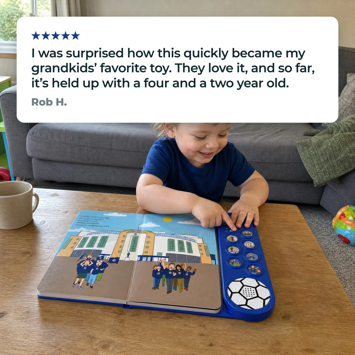 A young child in a plain navy top with the Sound Book open on a low table, a fingertip on one of the sound buttons, beside a five-star customer review.