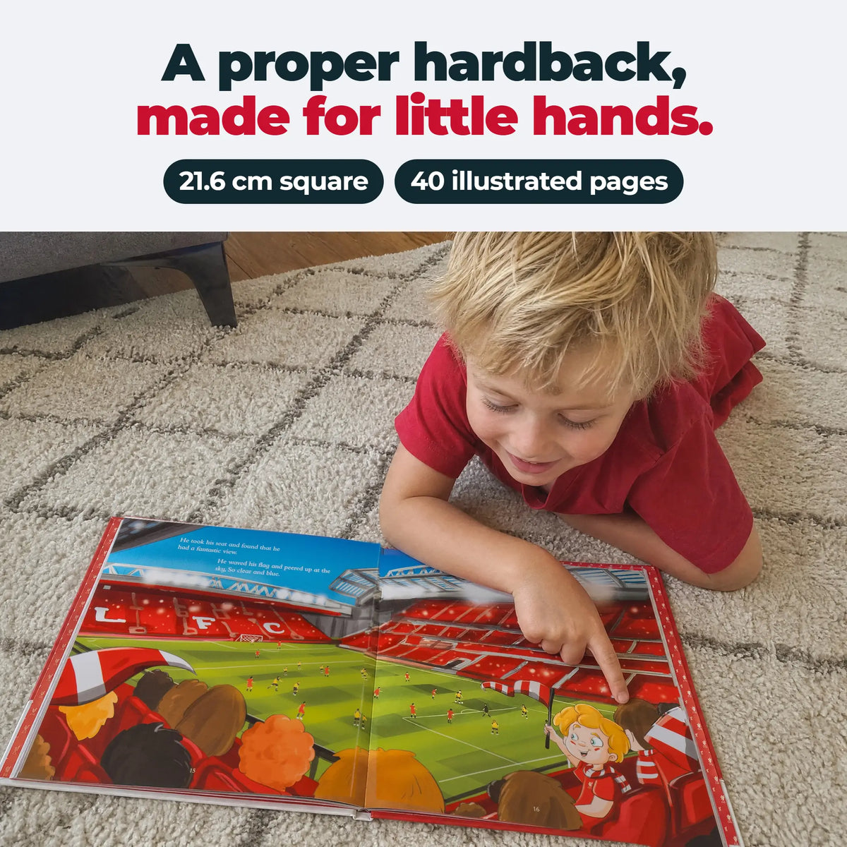 A child lying on the floor reading the Liverpool FC Personalised Book, open at an inside spread.