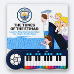 The Manchester City Piano Book, its cover, The Tunes of the Etihad, above the built-in keyboard with fourteen keys marked by colour and number.