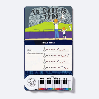 The Piano Book open flat at To Dare Is To Do, the Jingle Bells lyric and four lines of colour-coded notation printed above the fourteen-key keyboard.