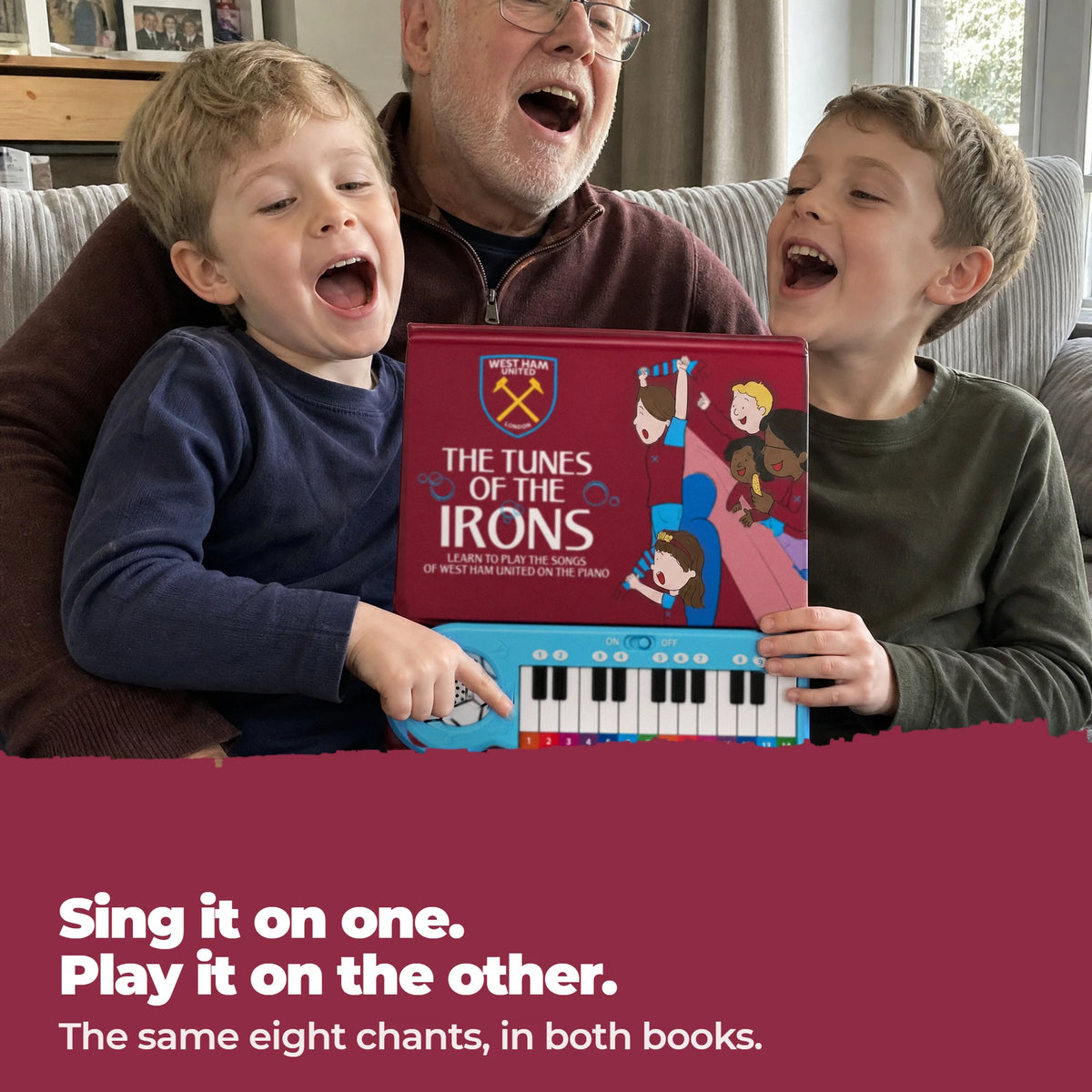 A grandad and his two grandsons singing together on the sofa, one boy playing the West Ham United Piano Book.