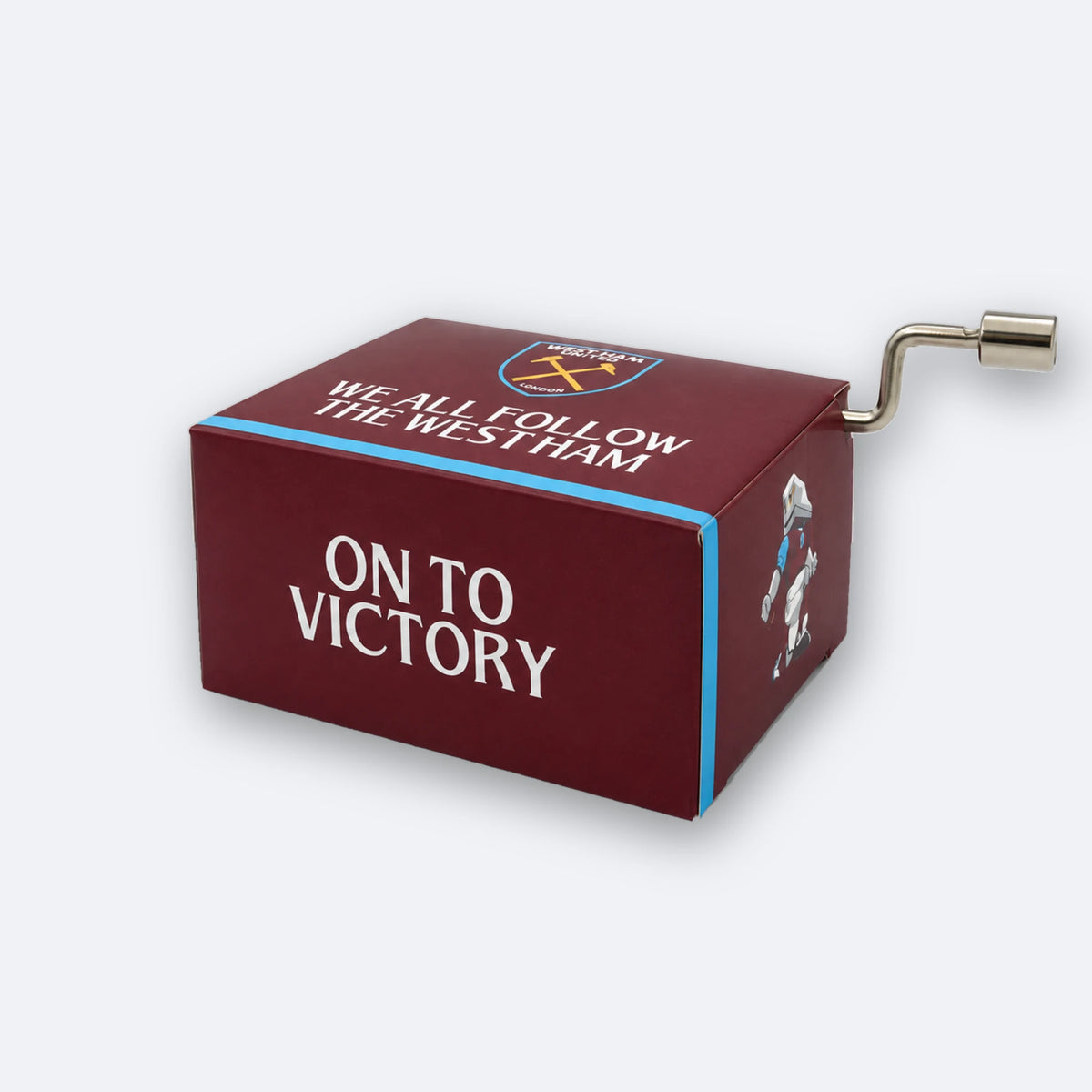 West-Ham-United-Spieluhr mit Handkurbel: eine weinrote Schachtel mit einem himmelblauen Streifen, oben mit dem Vereinswappen und WE ALL FOLLOW THE WEST HAM, vorne mit ON TO VICTORY bedruckt, mit einer kleinen Metallkurbel an der Seite.
