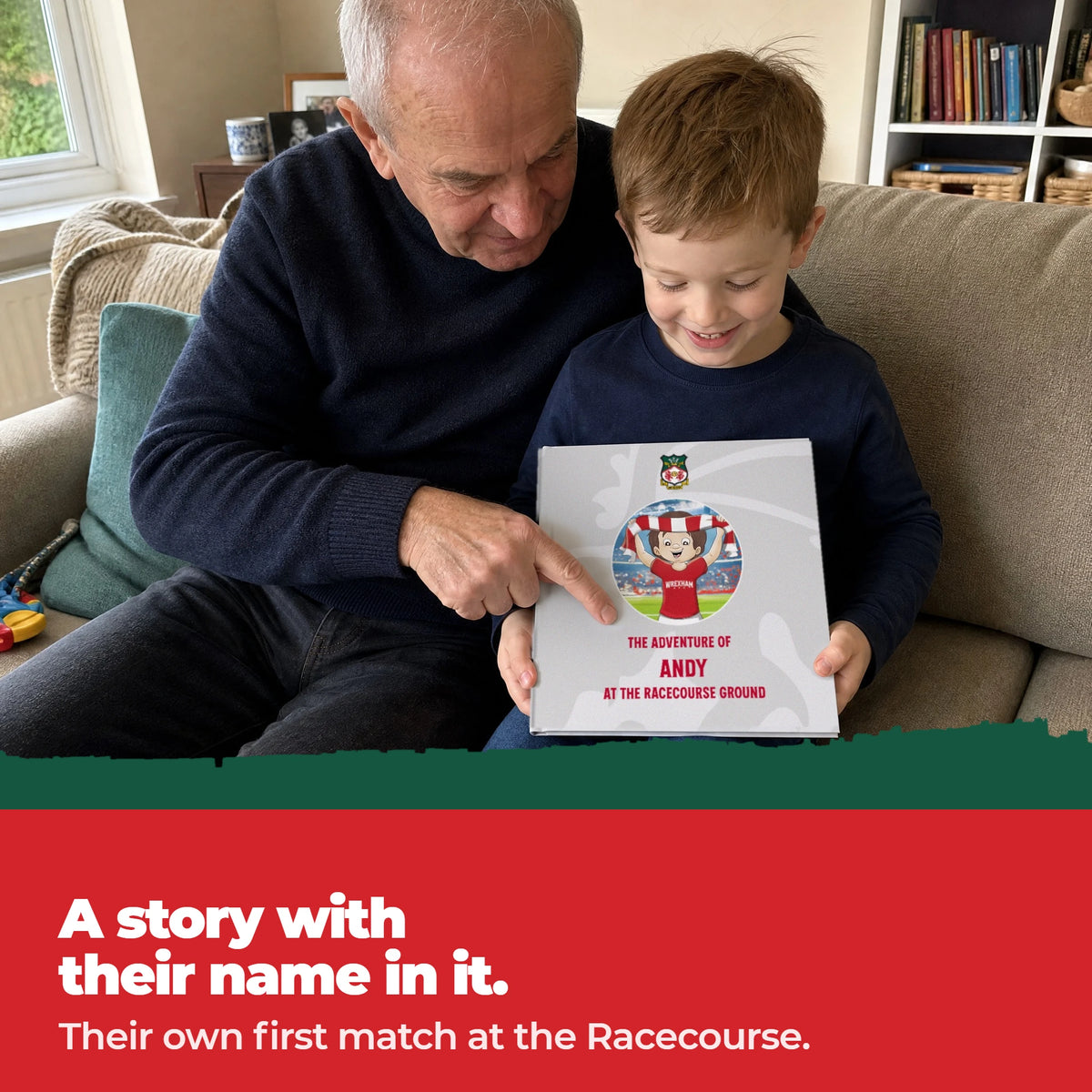 A grandad and his grandson on the sofa, the grandad pointing at the child's name printed on the cover of the Wrexham Personalised Book.