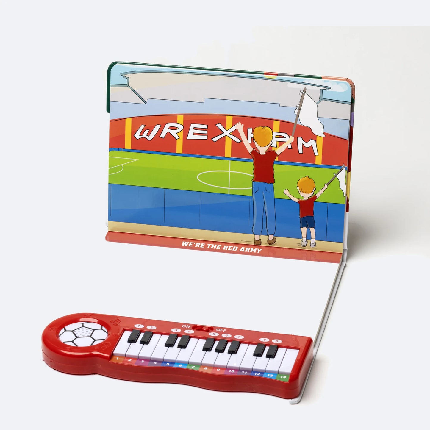The Piano Book open, showing an illustrated spread with colour-coded sheet music above the keyboard.