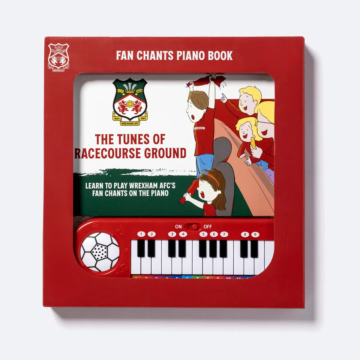 The Wrexham AFC Piano Book in its retail box, the keyboard visible through the window.