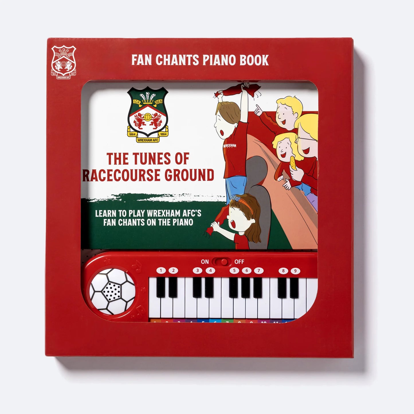 The Wrexham AFC Piano Book in its retail box, the keyboard visible through the window.