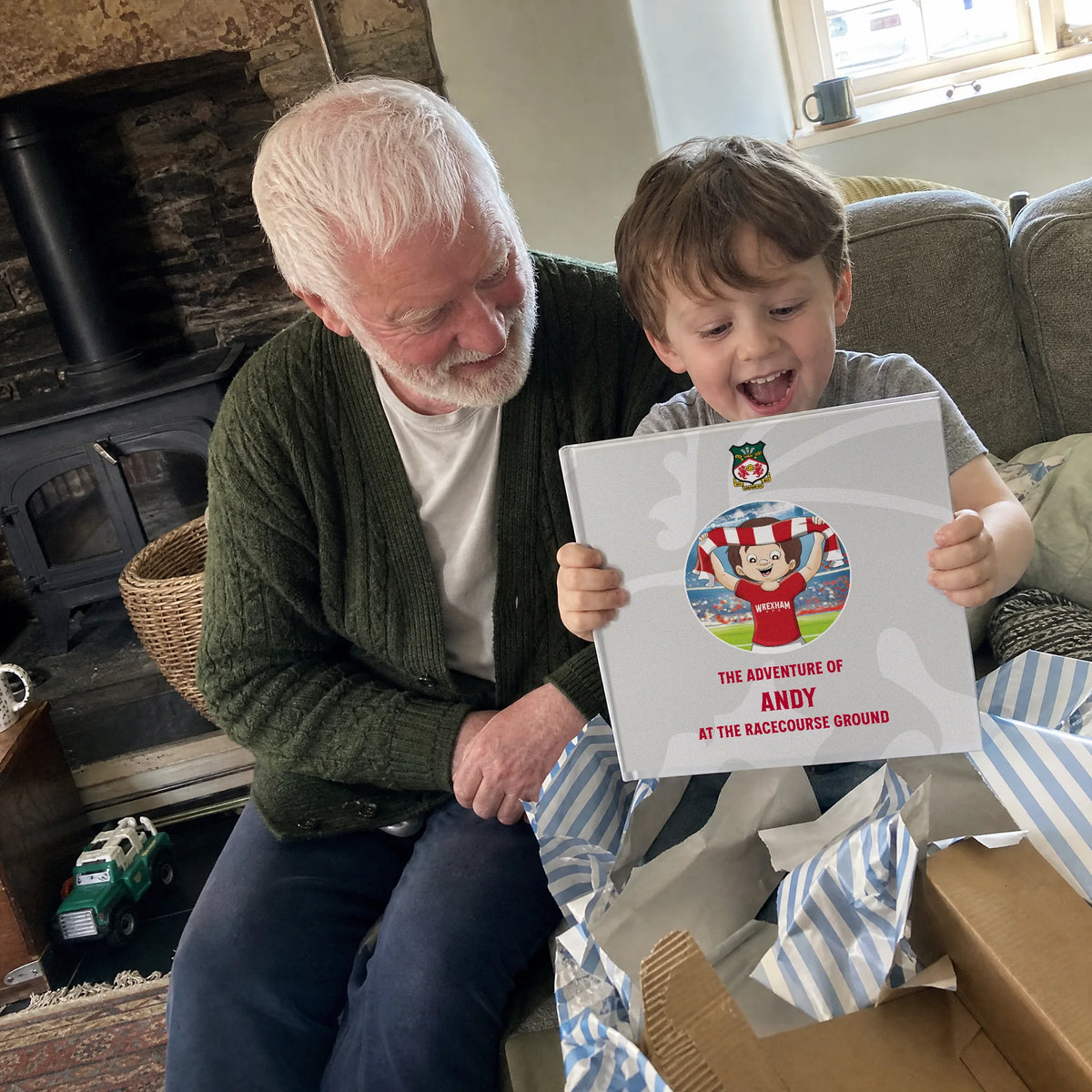 A grandad and his grandson by the fire, the Wrexham AFC Personalised Book just out of the wrapping paper.